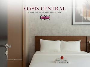 a bedroom with a bed with a sign that reads oasis central hold for your at Oasis Central Residence & Hotel - ZENITY CapitaLand in Ho Chi Minh City +9 photos