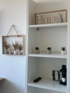 a room with white shelves with plants on them at Le petit chartreux in Grenoble