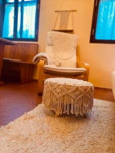 a living room with a chair and a rug at Naturnah bei Weimar in Nermsdorf