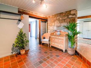 a room with a stone wall and a dresser and plants at Beautiful gîte in Jalhay 5 minutes from the Hautes Fagnes in Tiège +59 photos