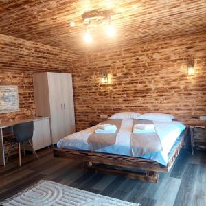 a bedroom with a bed and a wooden wall at Ema House in Vad +25 photos