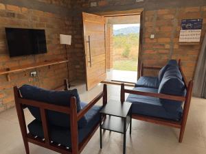 a living room with two chairs and a television at Shiwa riverside apartment 