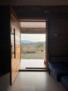 a door to a room with a view of a field at Shiwa riverside apartment 