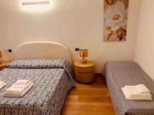 een kamer met twee bedden en een lamp op een tafel bij Piccolo Sogno in Desenzano del Garda +36 foto's