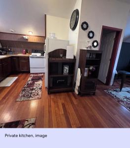 a kitchen with wooden floors and a white refrigerator at Ember Loft in Everett