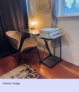 a table and two chairs and a table with two boxes on it at Ember Loft in Everett