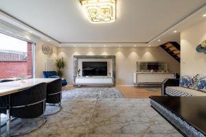 a living room with a table and a fireplace at La Maison de Rania - Moins dun km de la gare in Tourcoing