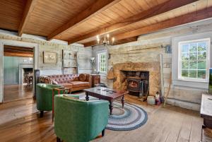 a living room with a couch and a fireplace at Historic 1802 Forge Home by North River & Trails in Capon Bridge