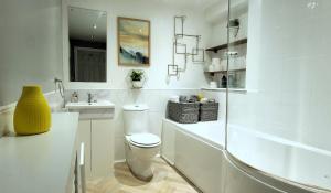 a white bathroom with a toilet and a sink at InstaLet Apartments I Wigan Central I Free Parking in Wigan +54 photos