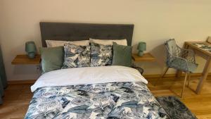a bedroom with a bed and a chair and a desk at Green Leaf Studio in Wrocław