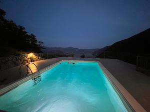 a swimming pool at night with a view at Balconi sul Lago - Stunning Lakeview and Pool in Parzanica