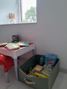 a box under a table next to a table at Gîte de l'Aubrigoux - Maison in Saint-Jean-dʼAubrigoux