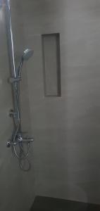 a white bathroom with a lamp on the wall at Trizen luxury apartments Colombo Sri lanka in Colombo +5 photos