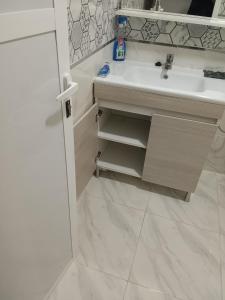 Monte ʼArrouitتجزئة الهناء العروي的一间白色浴室，配有洗手池和镜子。