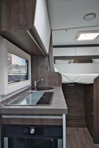 a kitchen with a sink in an rv at JR Autocaravanas in Las Puntas