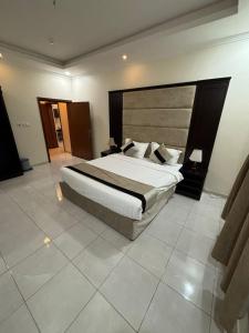 a bedroom with a large bed in a room at شقق أسس غين للشقق المخدومة in Yanbu +8 photos