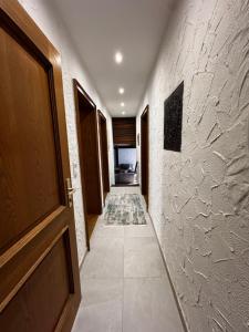 a hallway with a door and a tile floor at Aby Deluxe Wohnung in Rosenheim