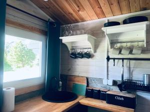 a kitchen with a counter with pots and pans at Domki w Lesie in Silnowo