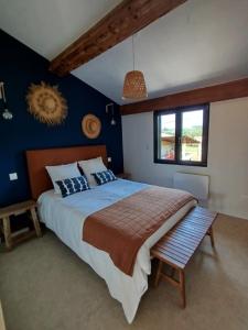 a bedroom with a large bed and a window at Les Tournesols gîte en pleine nature in Hounoux