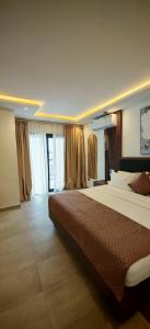 a large bedroom with a large bed and curtains at Le Feto in Dakar