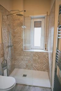 a bathroom with a shower and a toilet and a window at Room in Rome in Rome +12 photos