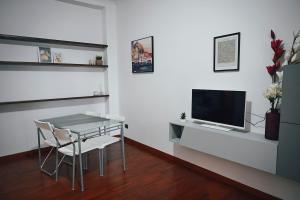 a living room with a table and a television at Room in Rome in Rome