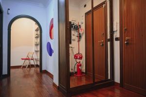 a hallway with a room with a fire extinguisher in it at Room in Rome in Rome