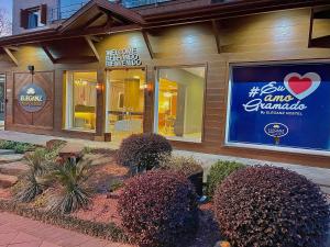 Un restaurante con un cartel en el lateral de un edificio. en Eleganz Suítes Exclusive Centro, en Gramado