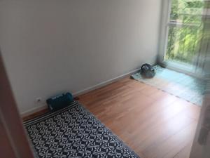 an empty room with a black and white rug and a window at Olembe Garden in Avon