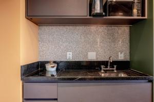 a kitchen with a sink and a counter top at BHomy Be Urban in Sao Paulo +40 photos