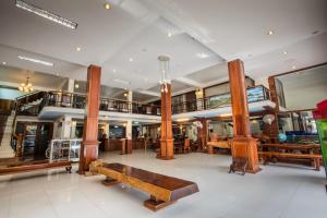 a large room with wooden furniture in a building at Seng Hout Hotel in Battambang