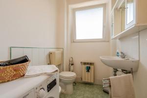 a bathroom with a sink and a toilet and a window at GuestHost - A Calanca - Comfy Le Grazie Apartment in Portovenere +8 photos
