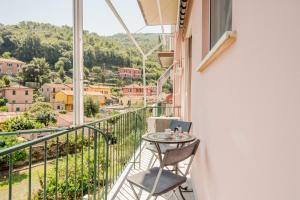 a balcony with a table and chairs and a view at GuestHost - A Calanca - Comfy Le Grazie Apartment in Portovenere