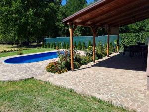 a patio with a gazebo and a blue pool at Villa Vein in Dragomance