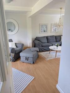 a living room with a couch and a table at Ferienhaus Deichblick in Tönning
