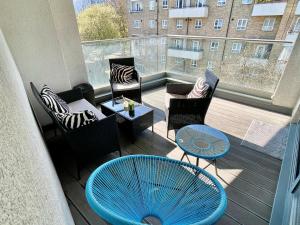 a balcony with a blue table and chairs on a balcony at Regents Park 3-BR flat w. balcony near Marylebone in London
