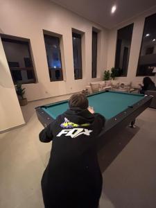a man standing in front of a pool table at Casa Malva, Palmilla, Santa Cruz in Estación Colchagua