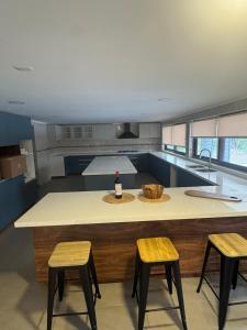 a kitchen with a large island with two stools at Casa Malva, Palmilla, Santa Cruz in Santa Cruz