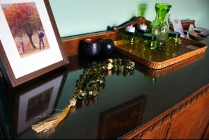 a table with a picture and some glasses and a picture at Grandmas Mansion 3BD Meteora - Rocks View in Kalabaka +13 photos