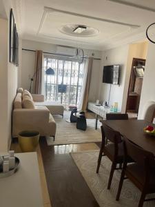 a living room with a couch and a table at Elie home in Douala