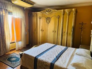 a bedroom with a bed with a ornate headboard at cairo1985-开罗1985 in Cairo