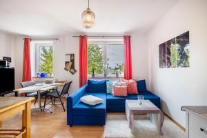 a living room with a blue couch and a table at Tiny Home in Lübeck