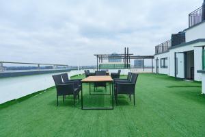 a patio with chairs and a table on a roof at Pearl Luxury Two Bedroom Apartment at Orchid Residency by Kaisa, Westlands, Nairobi in Nairobi