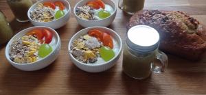 a table with bowls of food and a loaf of bread at Le numéro 5 in Bar-le-Duc