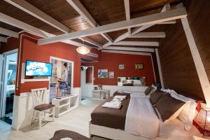 a bedroom with a large bed with red walls at Hotel Aria center in Tirana