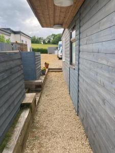 a side of a house with wooden walls at The Pigsty in Winford +11 photos