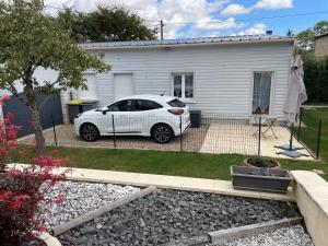 a white car parked in front of a house at Maison à la campagne in Combon