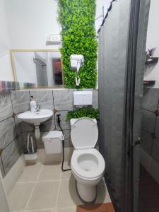 a bathroom with a toilet and a sink at Condo Stay near Philippine Arena - Chiara's Stay Inn in Marilao +13 photos