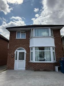 a brick house with a white door at Cosy 3 Bedroom Home, Parking & Bus in Oxford