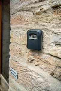 a black object on the side of a stone wall at Gite des Troix Ptites Noix - Family 9 People Garden Games Close to Cluny Vignoble in Savigny-sur-Grosne